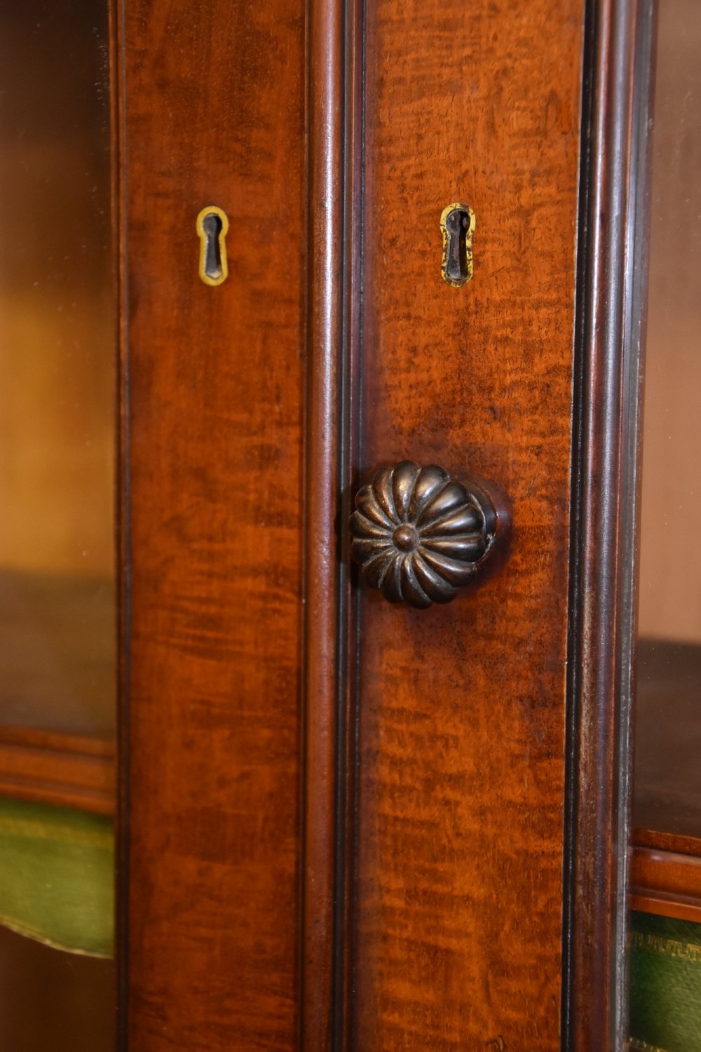 A large William IV mahogany triple bookcase cabinet featuring four upper glazed doors and three lower solid panelled doors. View IV