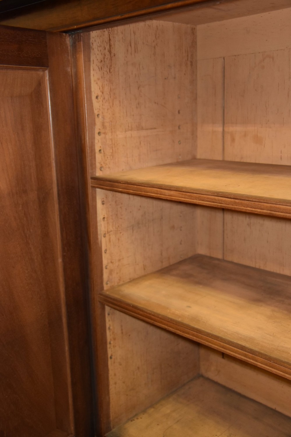 A large William IV mahogany triple bookcase cabinet featuring four upper glazed doors and three lower solid panelled doors. View V