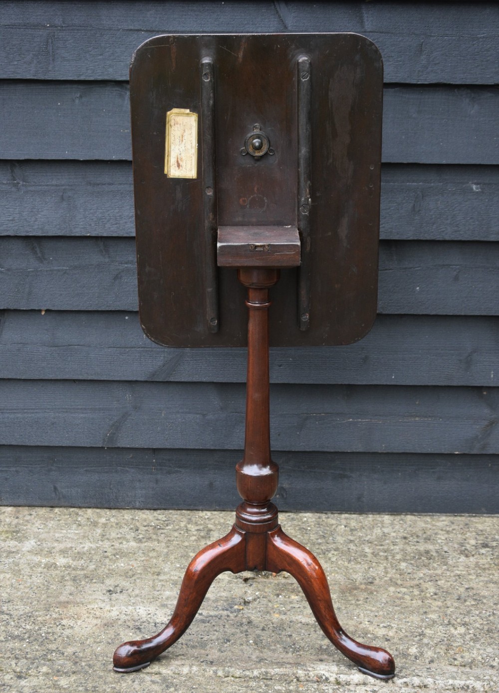 A 19th-century fruitwood tilt-top wine table with a rectangular rounded top, a turned column pedestal, and a tripod base. View II