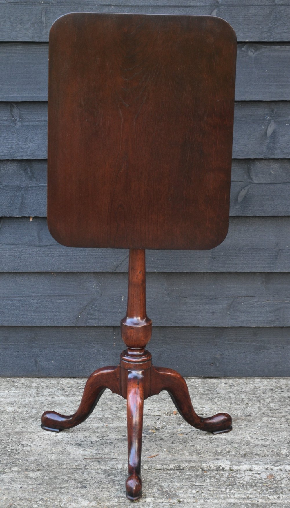 A 19th-century fruitwood tilt-top wine table with a rectangular rounded top, a turned column pedestal, and a tripod base. View VI