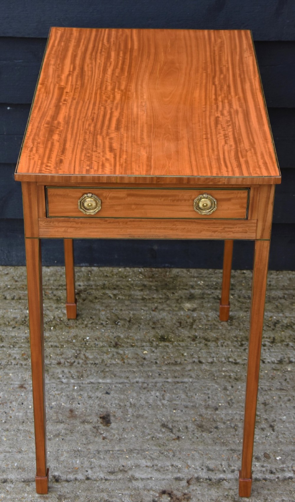 An antique Georgian satinwood lamp table featuring a single drawer with octagonal brass ring handles and slim square tapered legs. View III