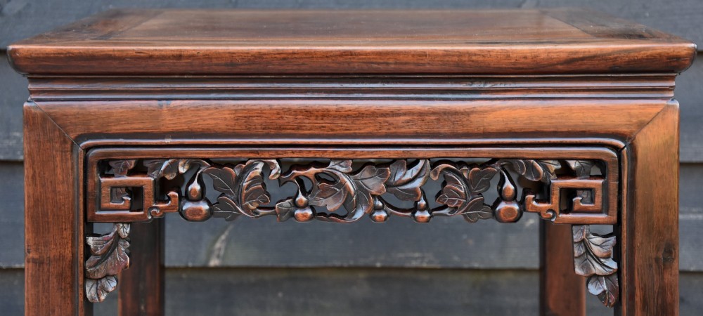 A square 19th-century Chinese rosewood low table featuring openwork carved aprons, straight legs, and scroll feet against a grey background. View III