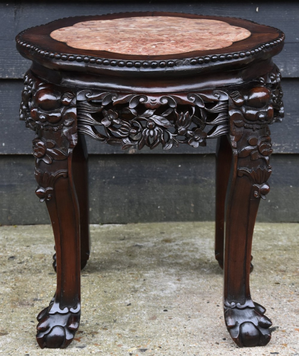 A circular 19th-century Chinese dark rosewood low table featuring an inset marble top, detailed floral openwork aprons, and cabriole legs ending in carved feet. View II