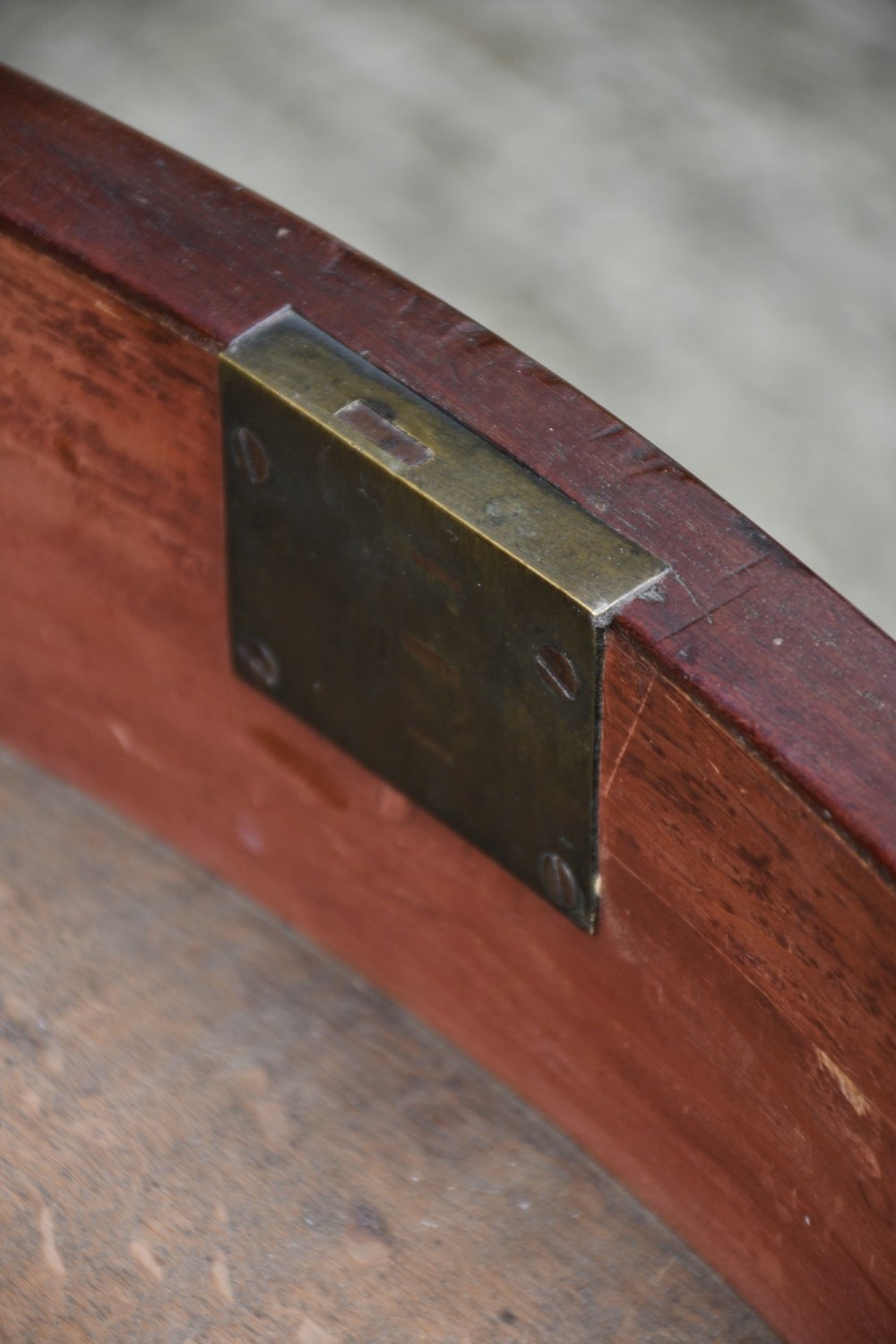 A late 18th-century Georgian mahogany serpentine chest of drawers featuring four graduated drawers with brass handles and bracket feet. View VI