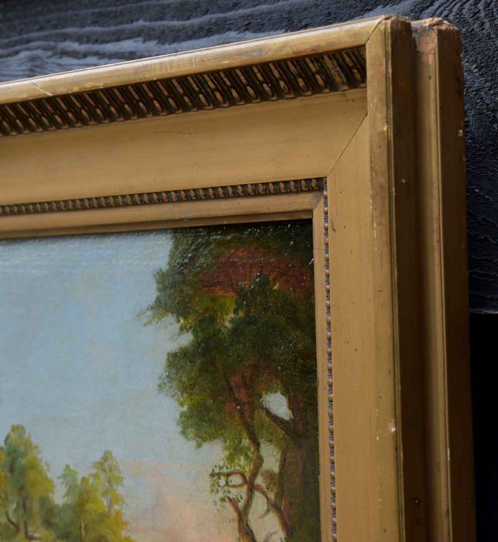 A 19th-century oil painting on board depicting a leafy woodland landscape with a path and distant hills, housed within a moulded gilt frame. View IV