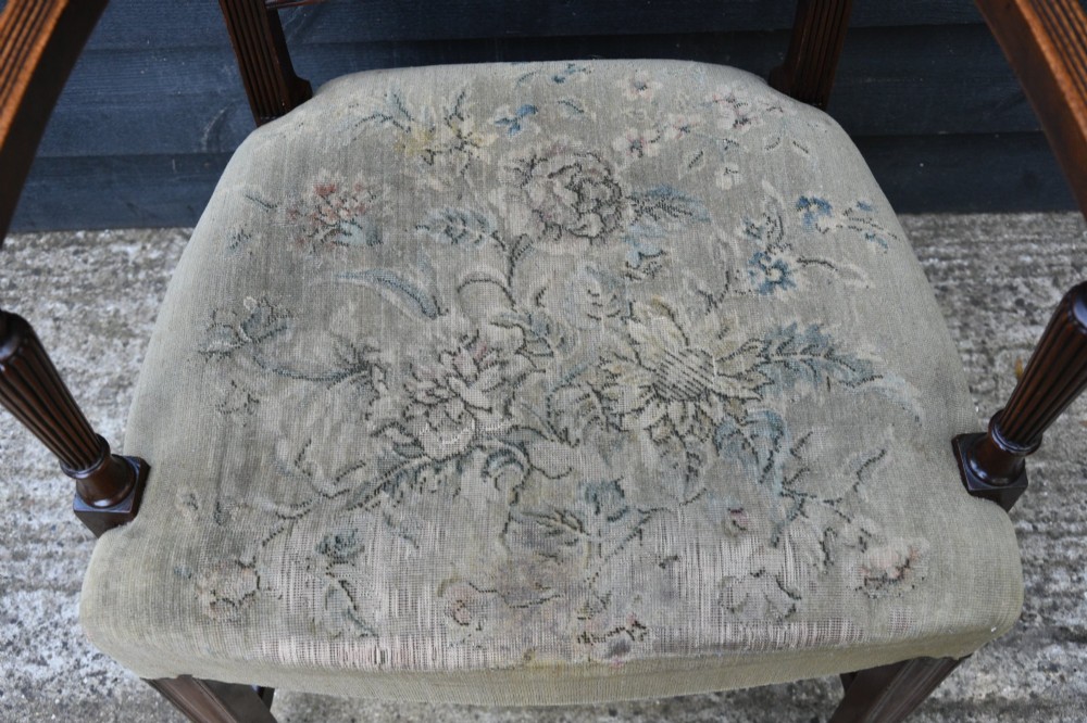 Set of six mahogany Georgian style dining chairs featuring spindle backrests, turned legs, and floral tapestry upholstery. View IX