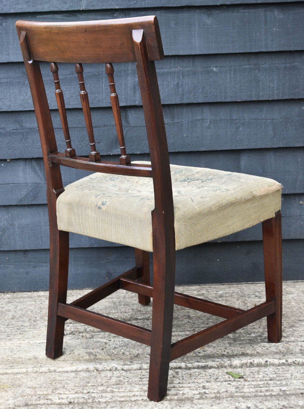 Set of six mahogany Georgian style dining chairs featuring spindle backrests, turned legs, and floral tapestry upholstery. View XII