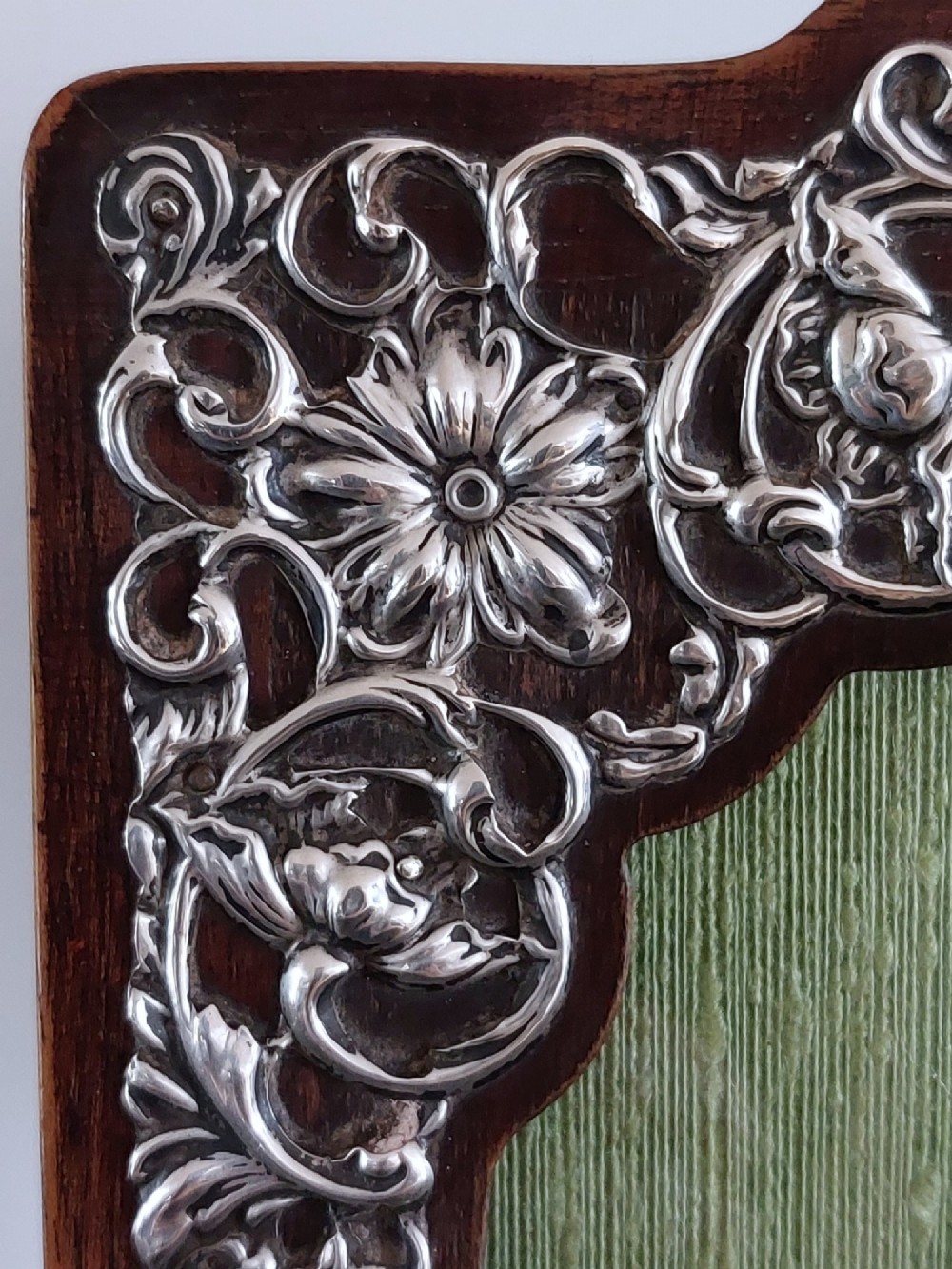 A pair of rectangular Edwardian photo frames featuring pierced scrollwork silver fronts mounted onto dark hardwood backings. View VI