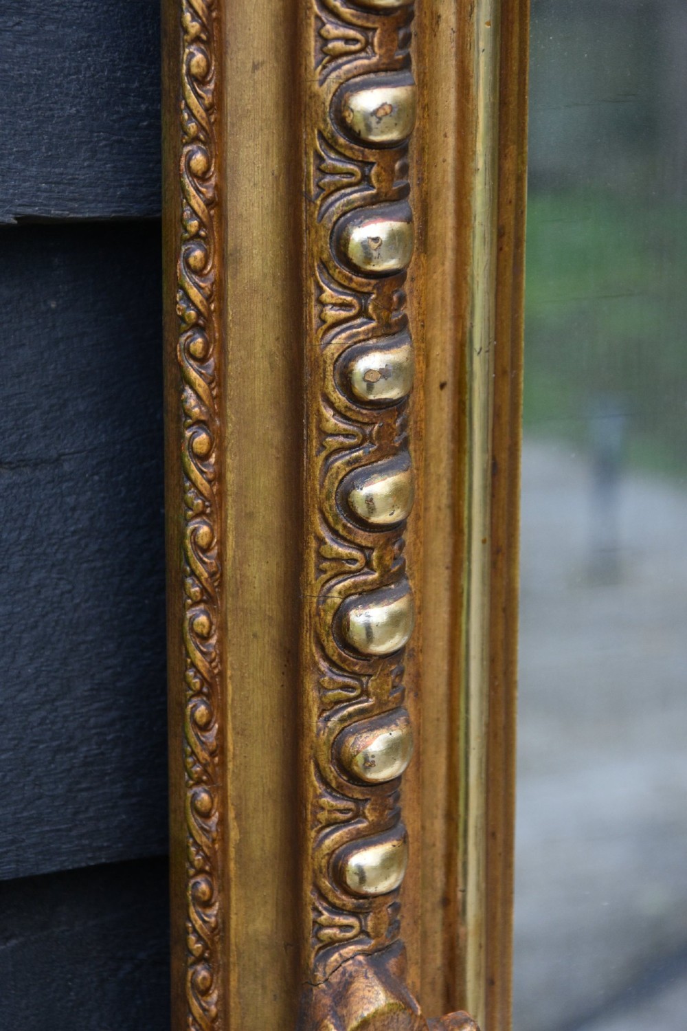 A French giltwood pier mirror featuring a carved rocaille cresting, mounted above a matching marble-topped console table with cabriole legs. View VII