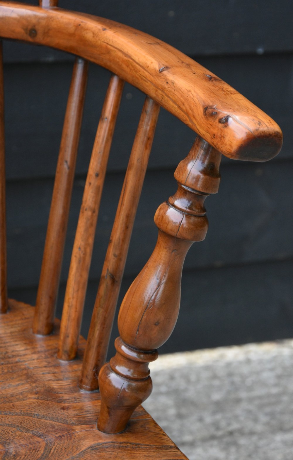 A 19th-century English Windsor armchair made from yew and elm wood featuring a hoop back, a central pierced splat, turned legs, and a crinoline stretcher. View III