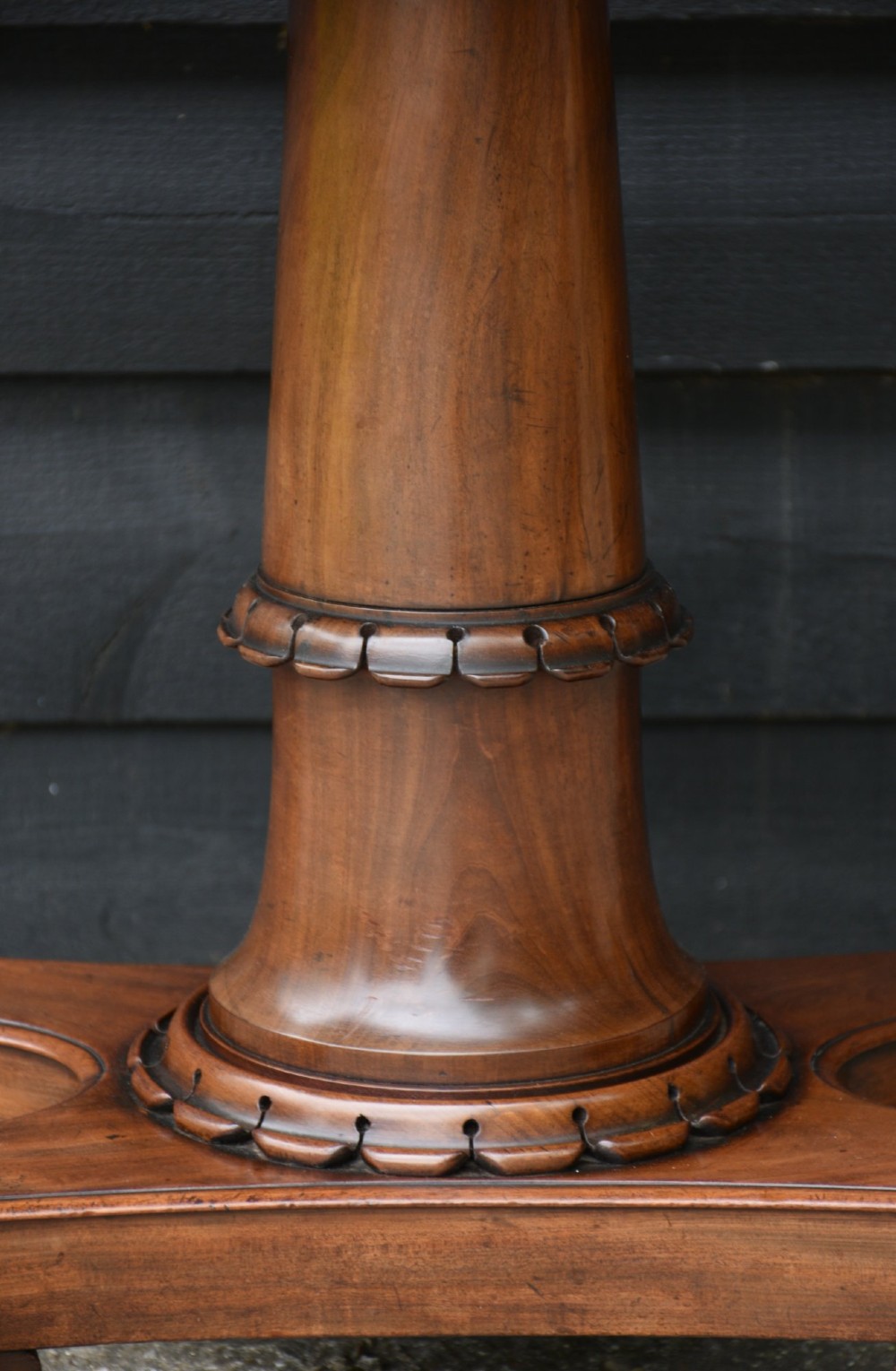 A 19th-century William IV mahogany fold-over card table featuring a rectangular swivel top resting on a tapered pedestal column and quadform base with carved lion paw feet. View III