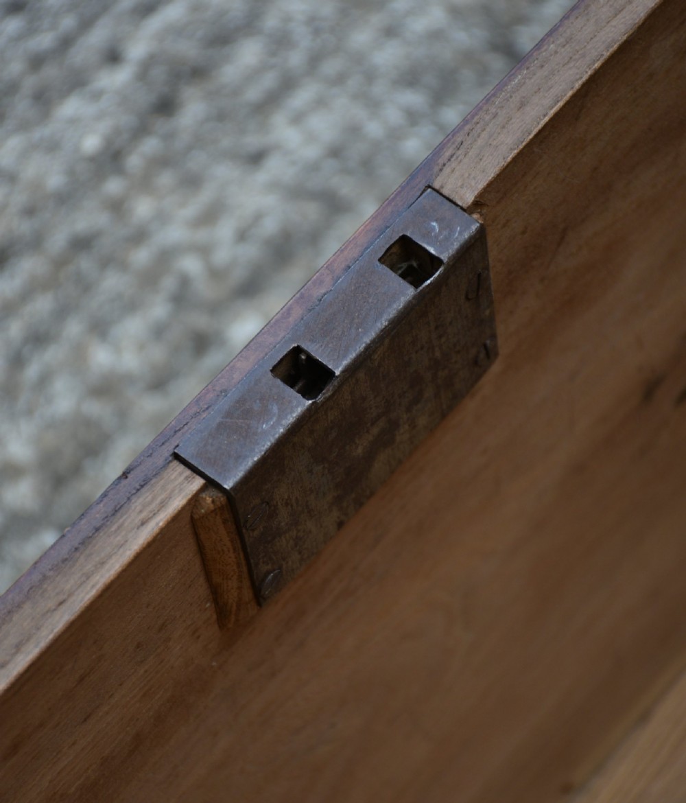 A rectangular Georgian elm blanket box featuring a hinged top lid, front keyhole, side iron handles, and a simple plinth base. View IX