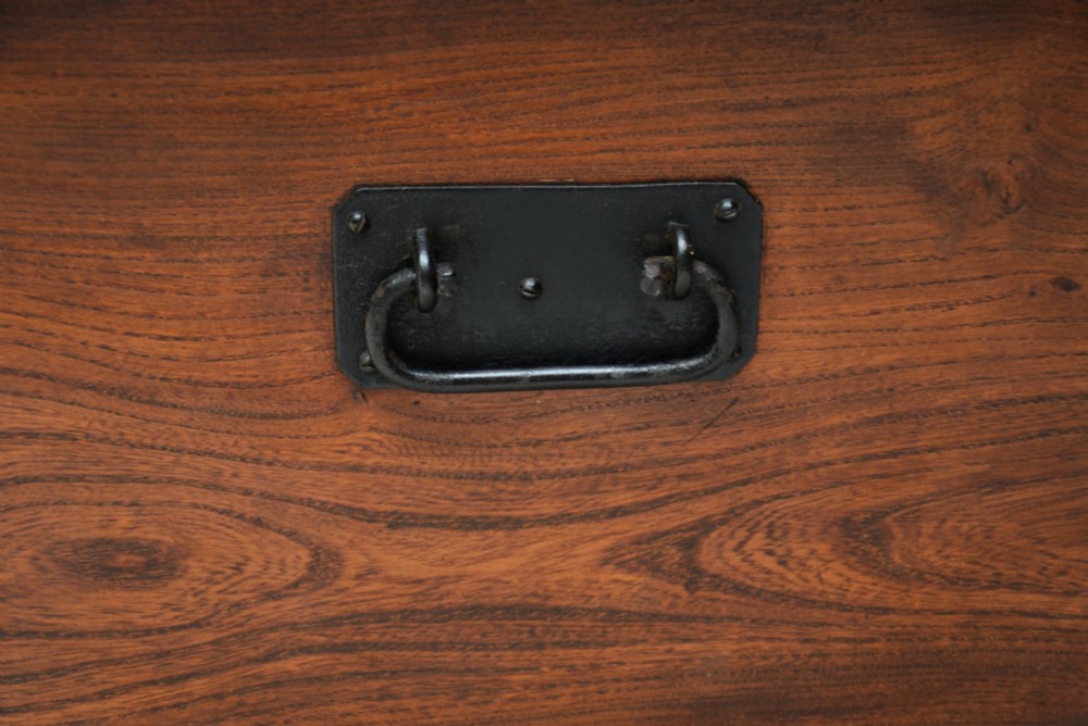 A rectangular Georgian elm blanket box featuring a hinged top lid, front keyhole, side iron handles, and a simple plinth base. View XI