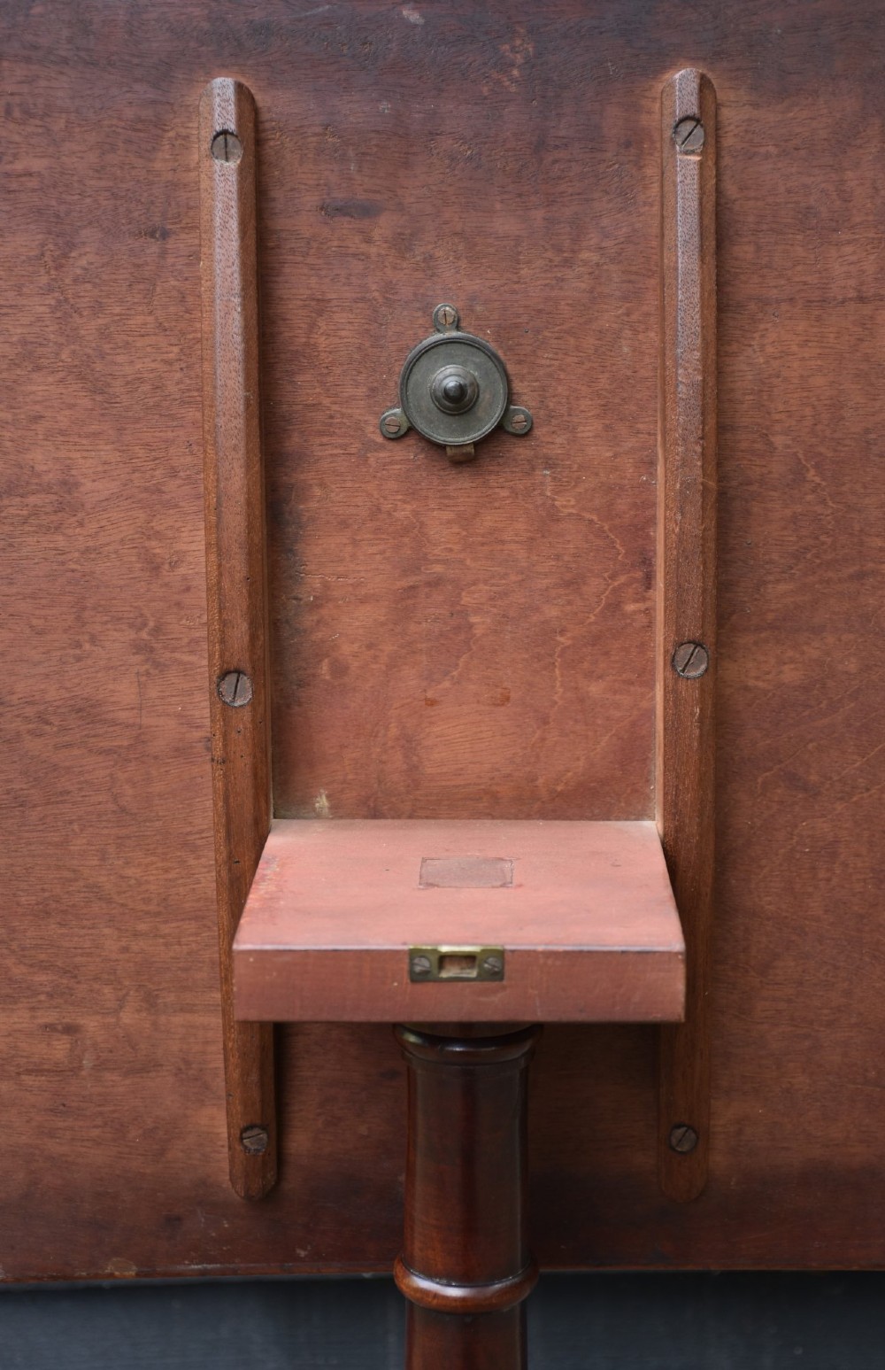 A 19th-century mahogany tilt-top wine table with a rectangular rounded surface, turned pedestal column, and three splayed legs. View IV