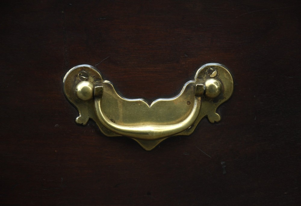 A Georgian mahogany travelling chest featuring side brass carrying handles, an escutcheon lock, and raised bracket feet. View VIII