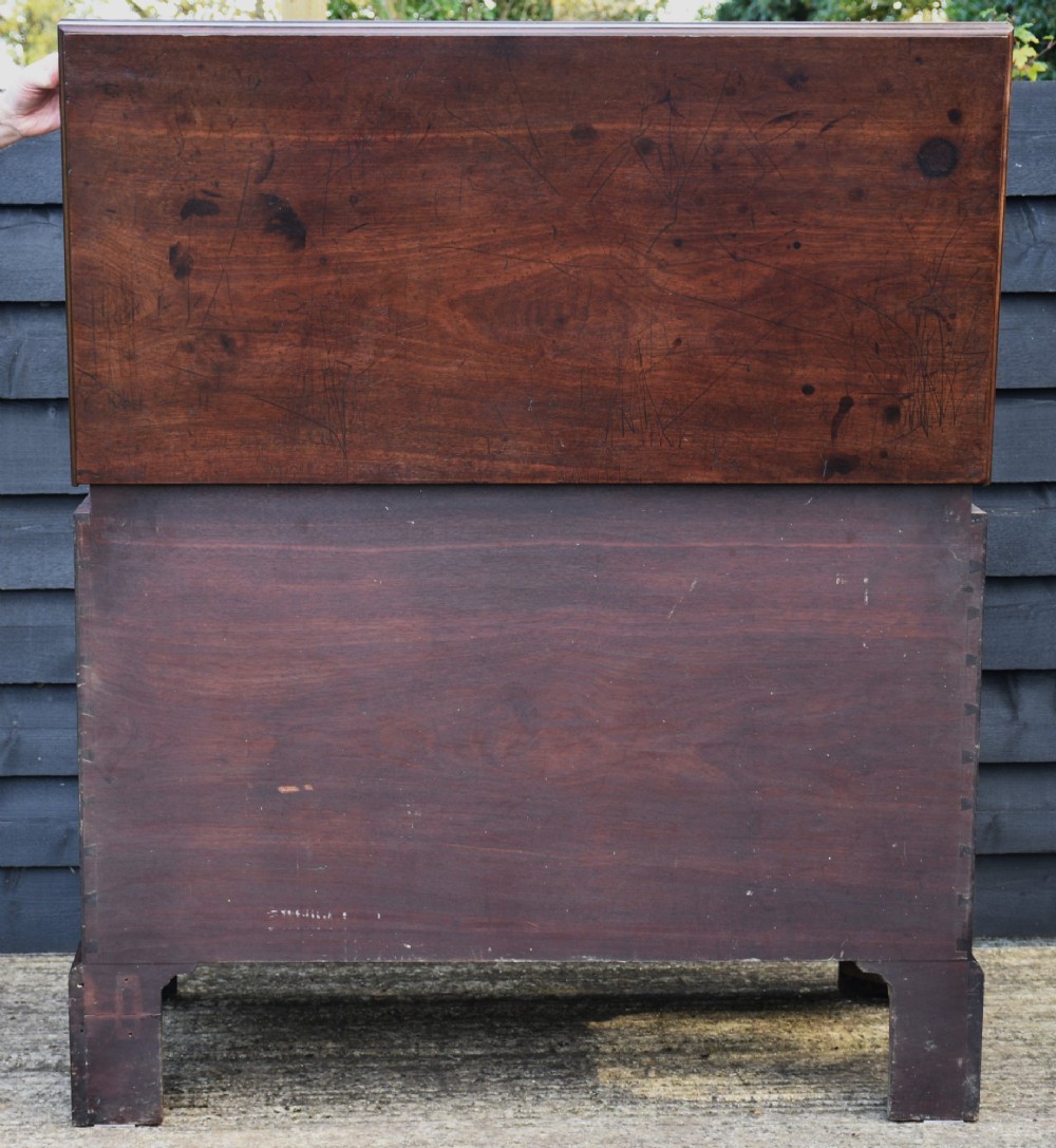 A Georgian mahogany travelling chest featuring side brass carrying handles, an escutcheon lock, and raised bracket feet. View XI
