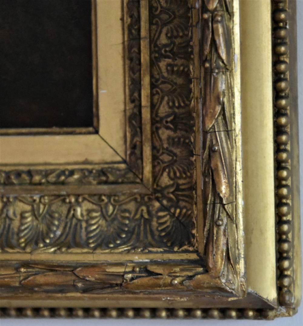 An Edwardian oil painting on board depicting a young lady in an 18th-century style dress and feathered hat, presented in an ornate gilt frame. View IV