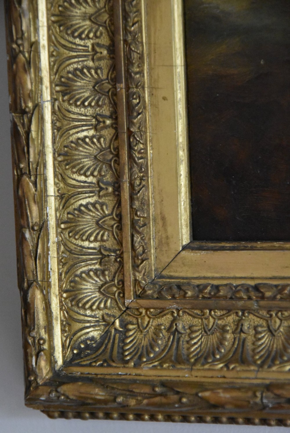 An Edwardian oil painting on board depicting a young lady in an 18th-century style dress and feathered hat, presented in an ornate gilt frame. View V