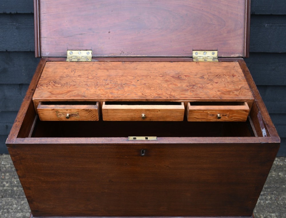 A 19th-century mahogany box on stand featuring cabriole legs, pad feet, brass side carrying handles, and a key with a pink tassel. View V