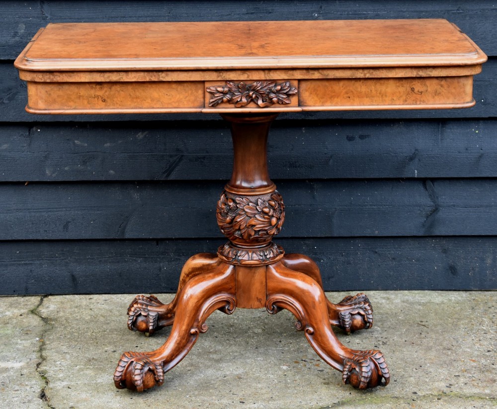 A 19th-century Victorian burr walnut card table featuring a fold-over top, carved central pedestal, and quadform cabriole legs. View II