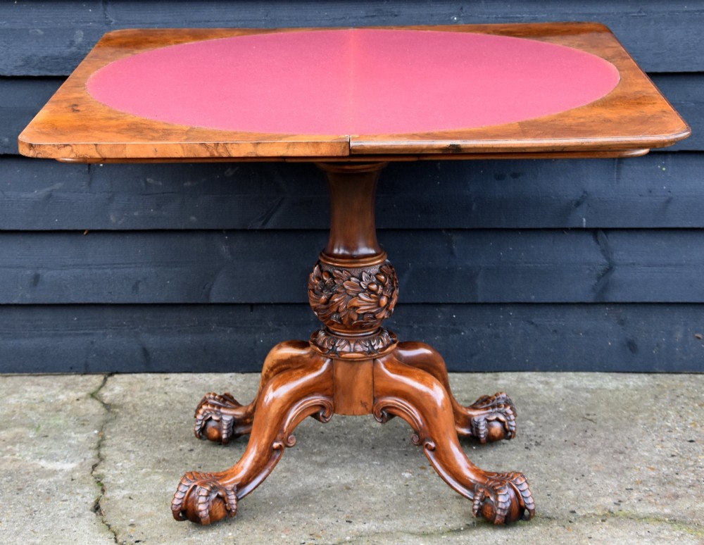 A 19th-century Victorian burr walnut card table featuring a fold-over top, carved central pedestal, and quadform cabriole legs. View V