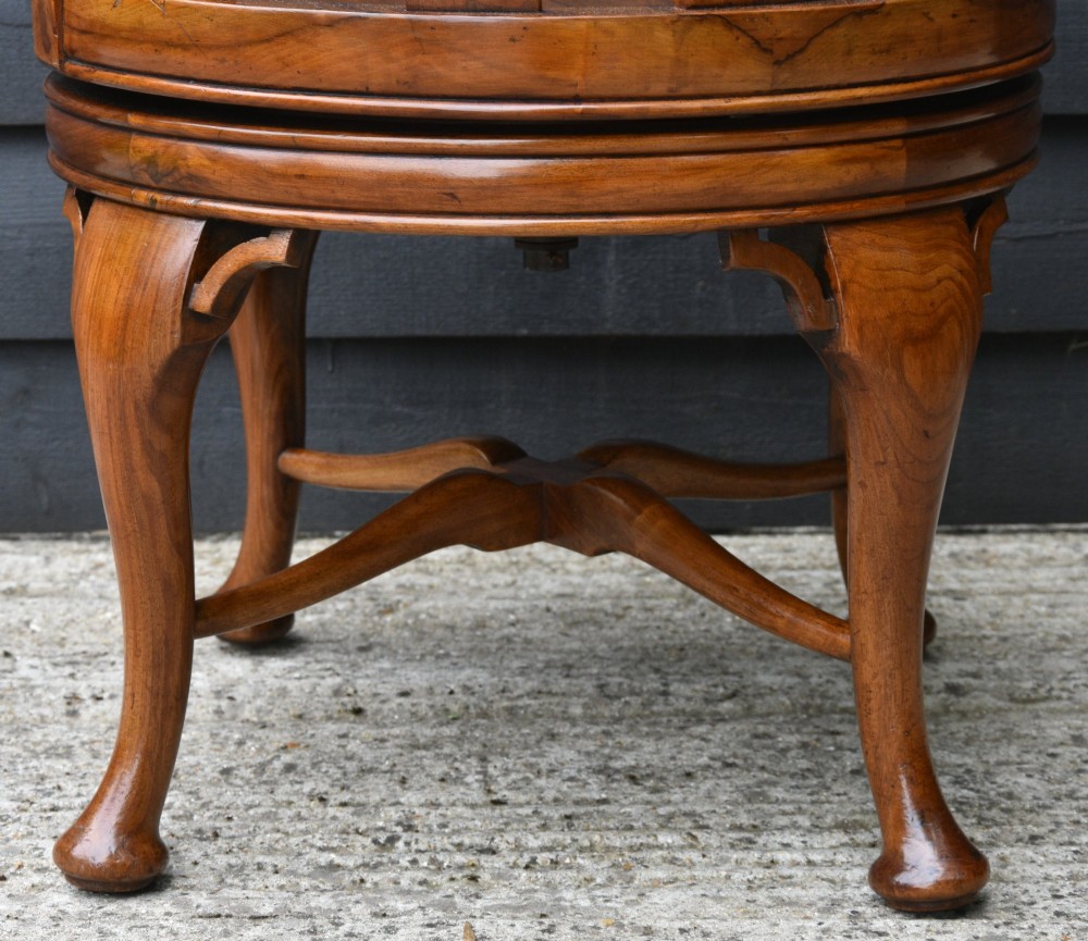 A carved walnut revolving desk chair featuring a Gothic pointed arch backrest with open tracery splats and cabriole legs. View VII