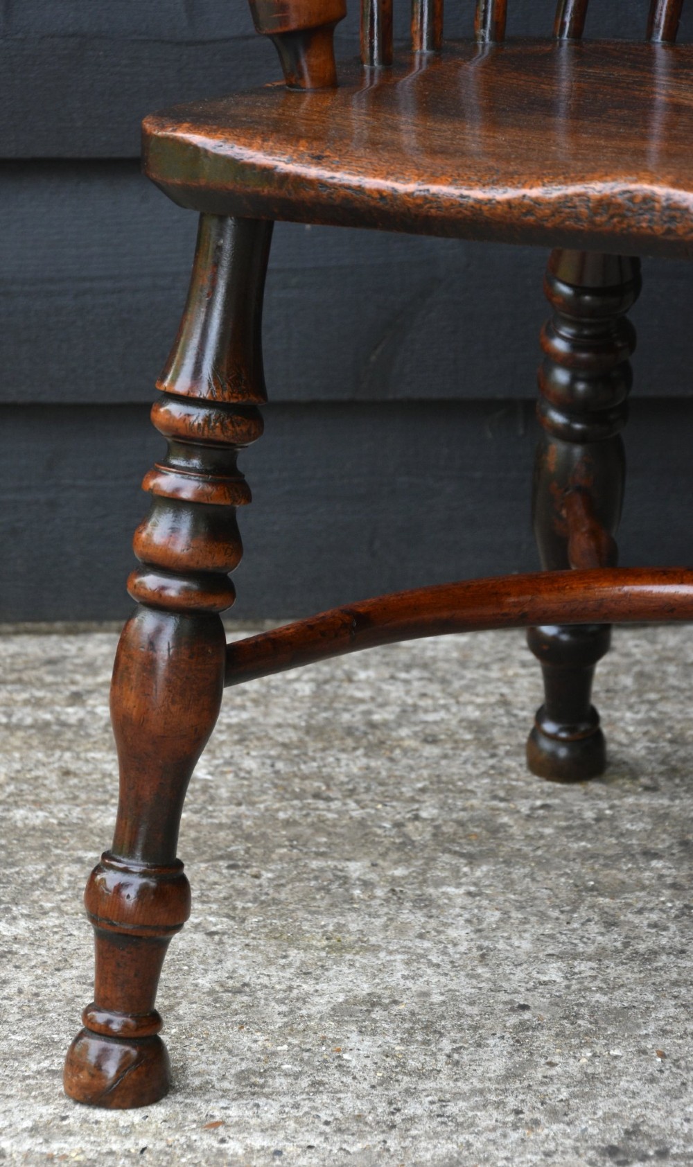 A matched pair of 18th-century Georgian yew and elm Windsor armchairs featuring curved hoop backs, pierced central splats, saddle seats, and turned legs. View VIII