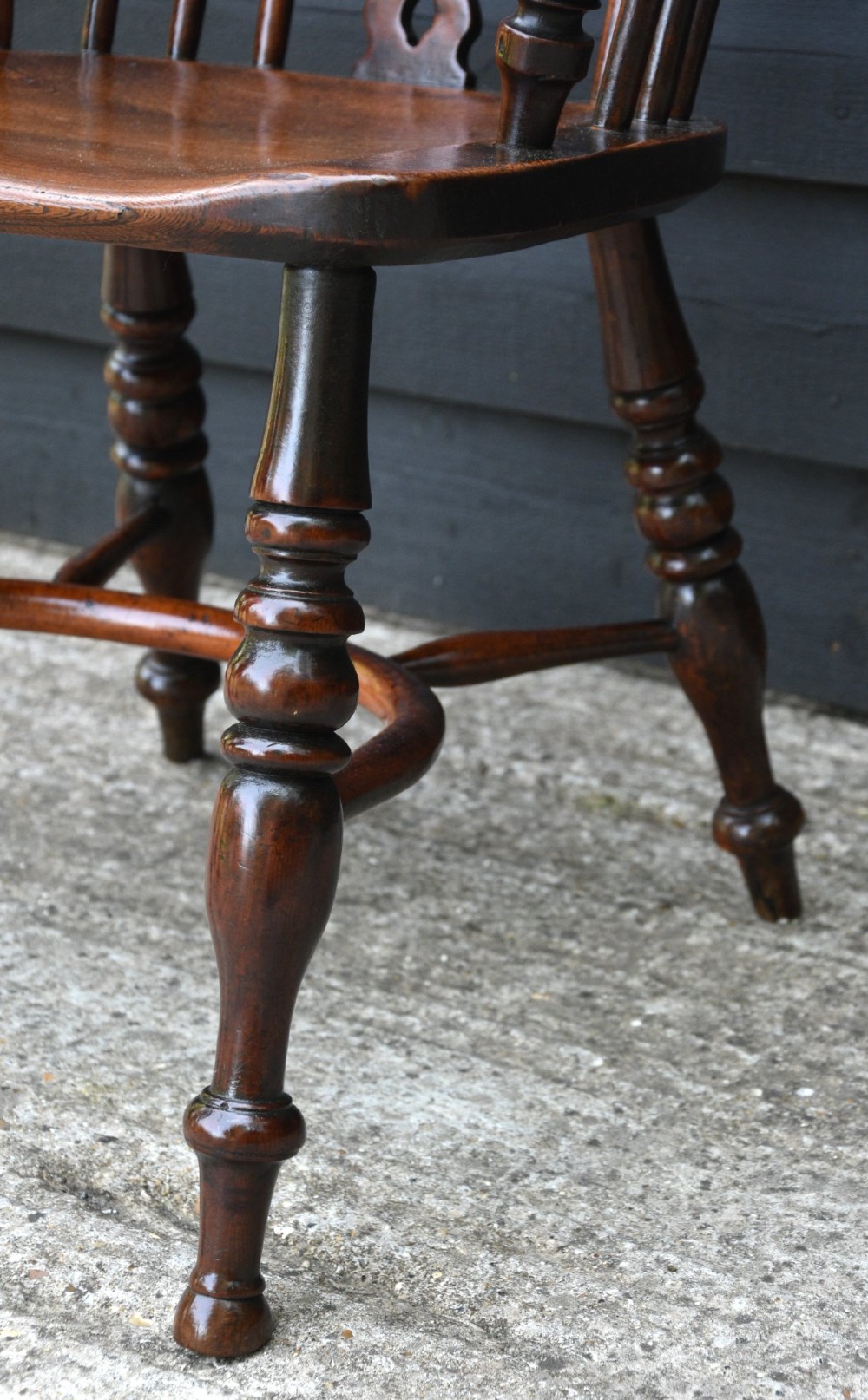 A matched pair of 18th-century Georgian yew and elm Windsor armchairs featuring curved hoop backs, pierced central splats, saddle seats, and turned legs. View XV
