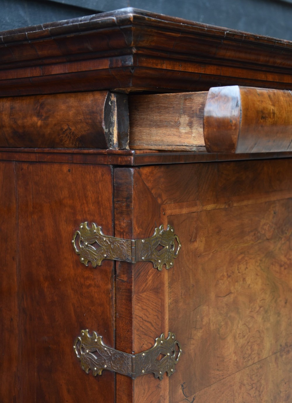 A seventeenth-century William and Mary walnut cabinet on chest featuring double doors with decorative brass hinges above three drawers on bun feet. View VIII