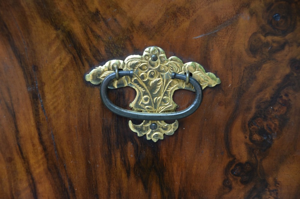 A seventeenth-century William and Mary walnut cabinet on chest featuring double doors with decorative brass hinges above three drawers on bun feet. View IX