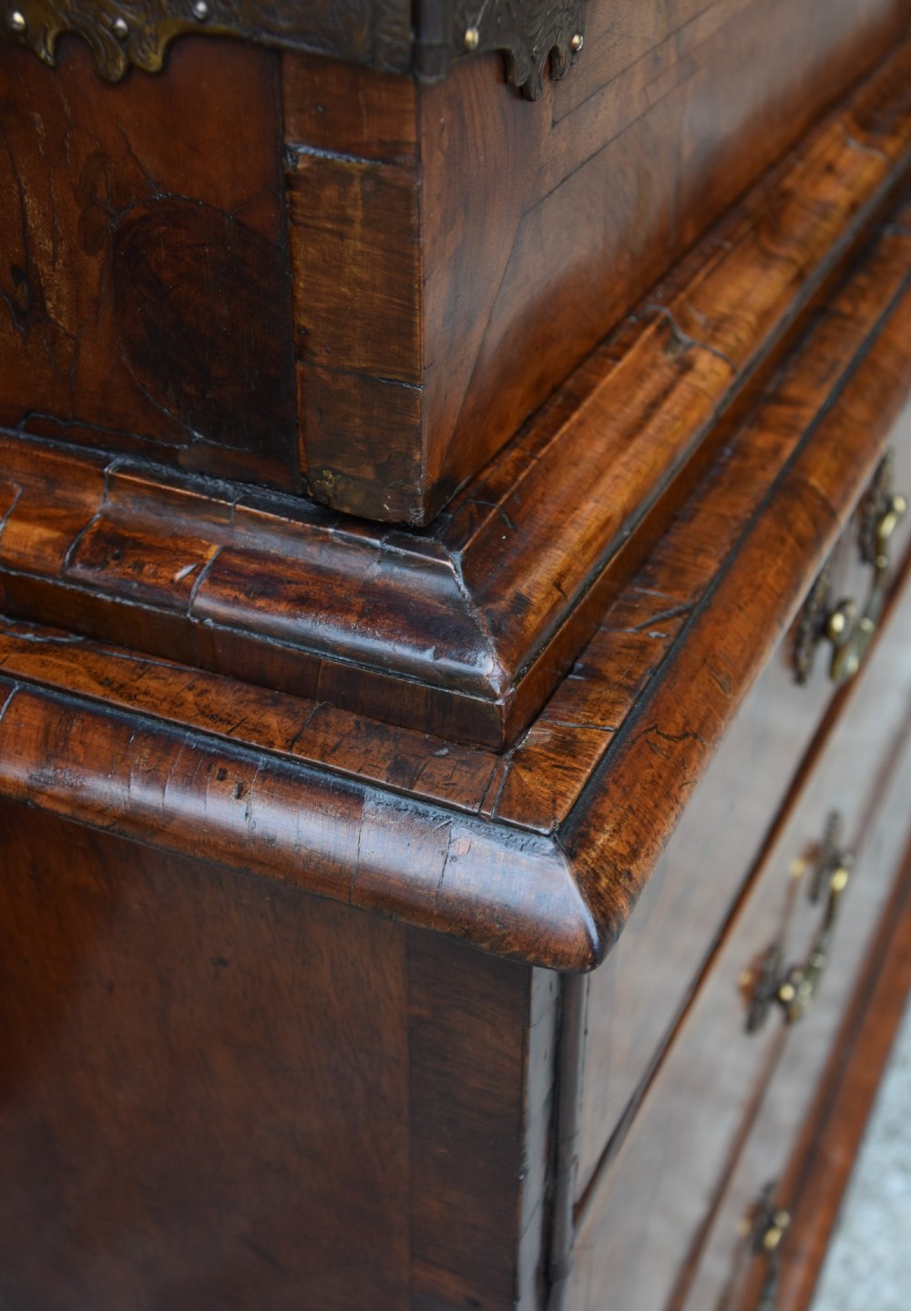 A seventeenth-century William and Mary walnut cabinet on chest featuring double doors with decorative brass hinges above three drawers on bun feet. View XIII
