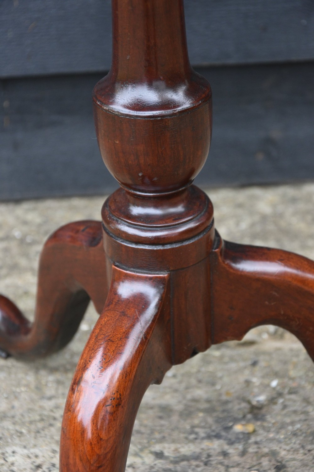 A 19th-century fruitwood wine table featuring a rectangular tilt top on a turned pedestal column with tripod cabriole legs. View V