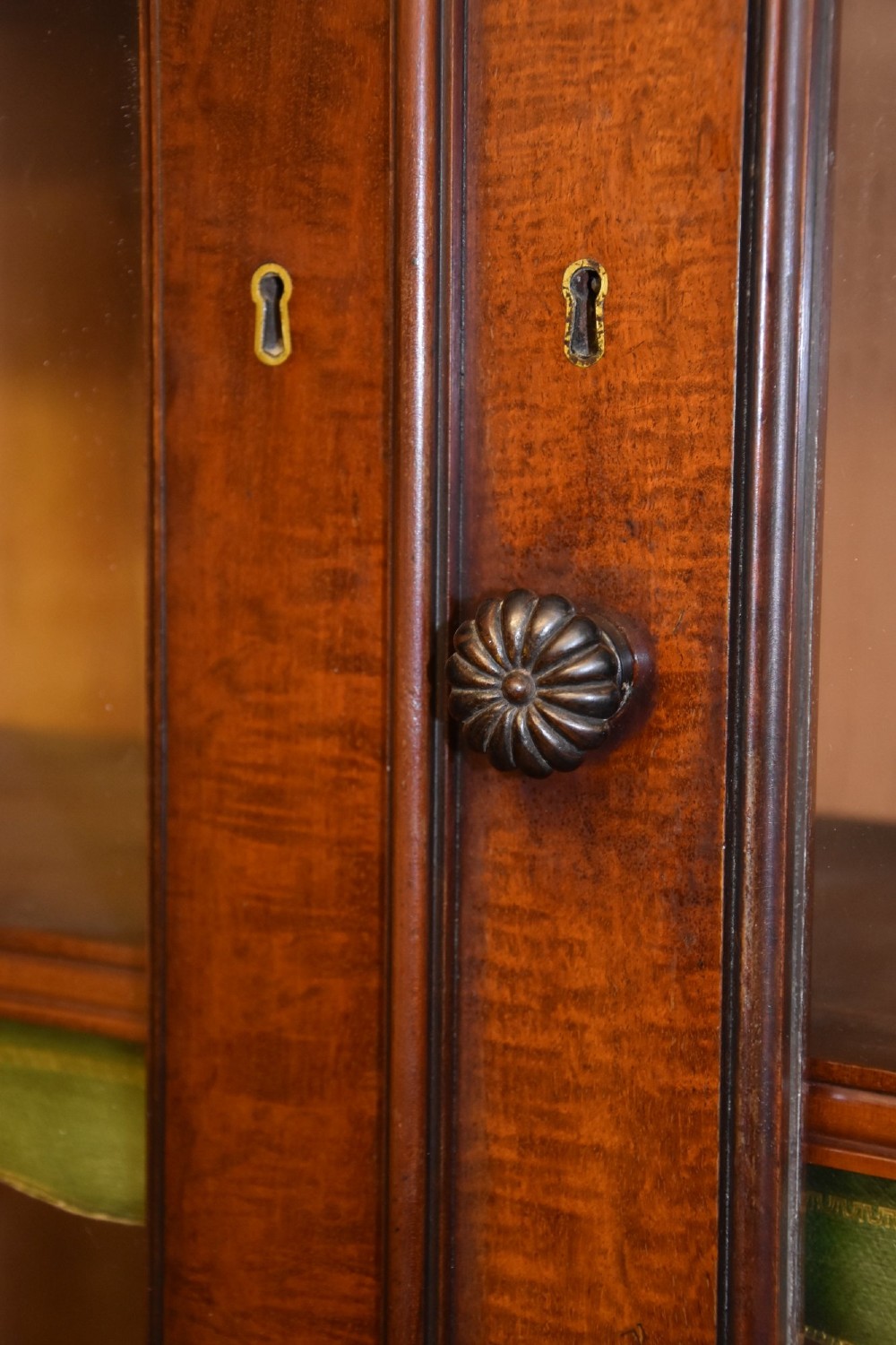 A large 19th-century William IV mahogany library bookcase cabinet featuring glazed upper doors above panelled lower cupboard doors. View IV