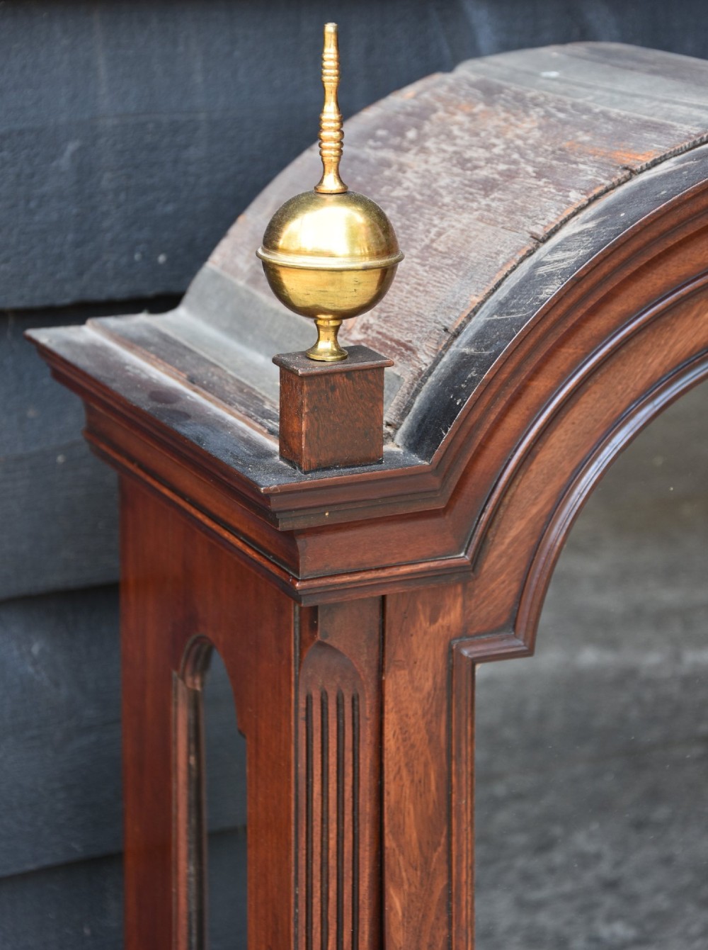 An 18th-century Georgian longcase clock in flame mahogany with an arched brass dial and brass finials. View XIII