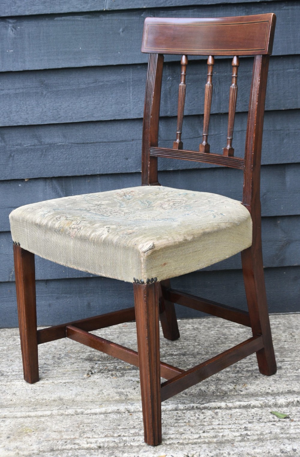 A set of six mahogany Georgian style dining chairs with turned spindle backrests, reeded arms, and floral tapestry upholstery. View X