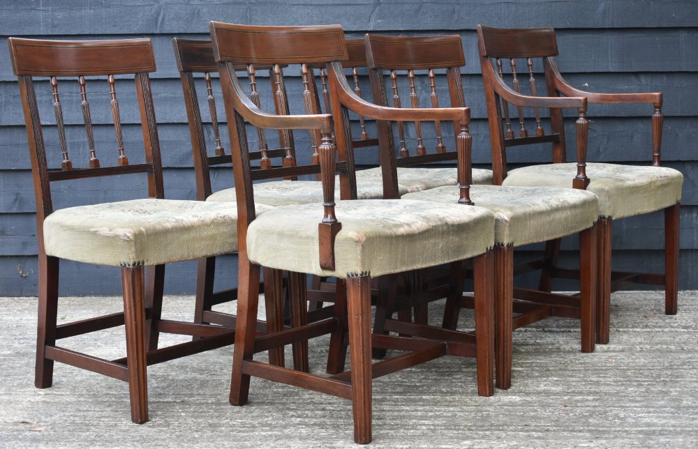 A set of six mahogany Georgian style dining chairs with turned spindle backrests, reeded arms, and floral tapestry upholstery. View XII