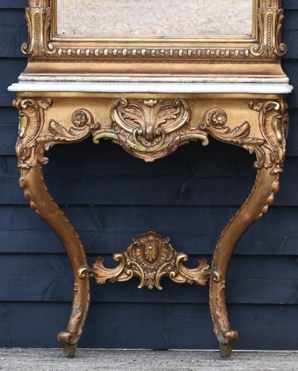 A 19th-century French giltwood pier mirror with an ornate shell crest mounted above a matching carved console table featuring a marble top. View VI