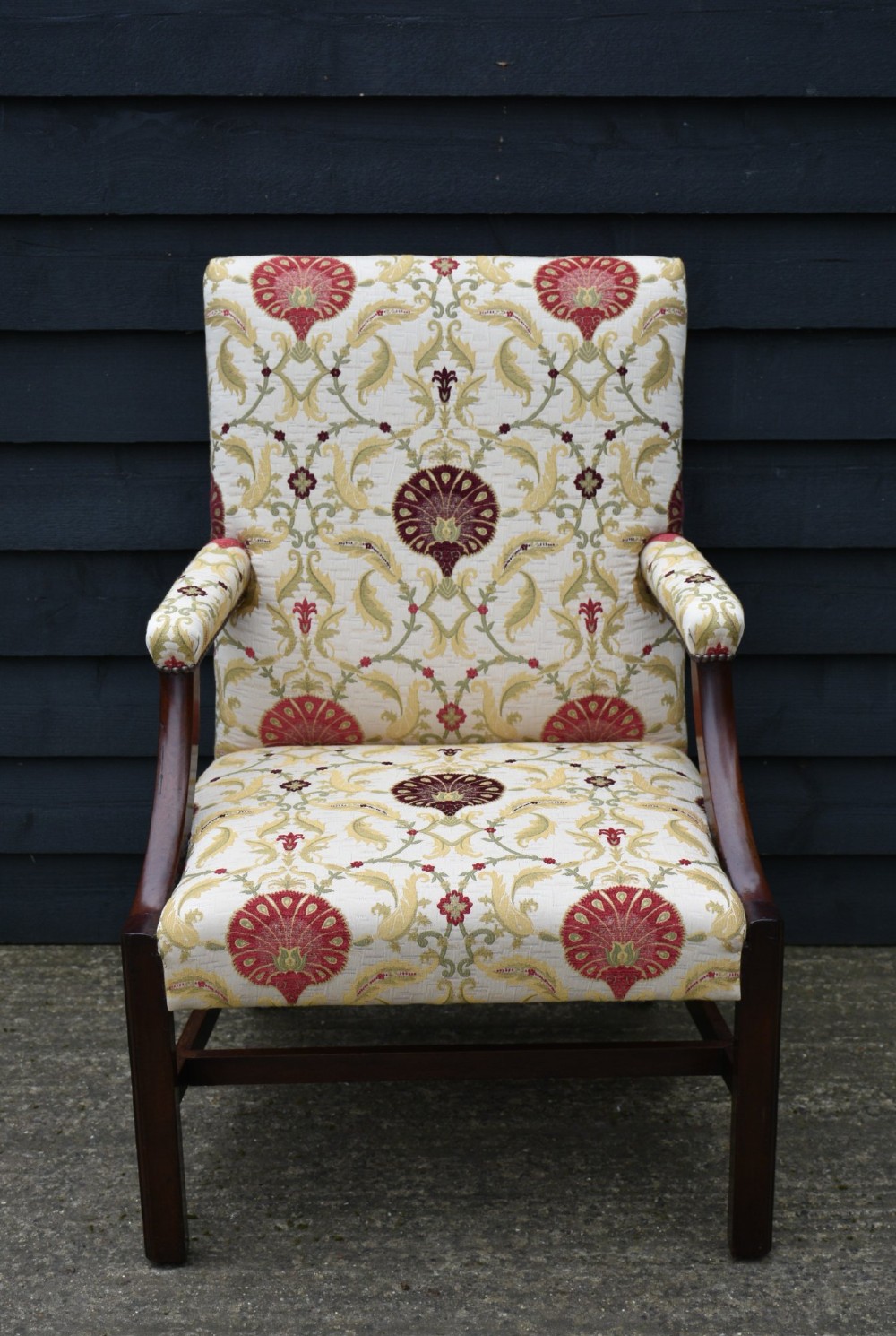 A Georgian Gainsborough armchair featuring cream and red floral upholstery, open mahogany arms, and a solid timber frame with stretchers. View III