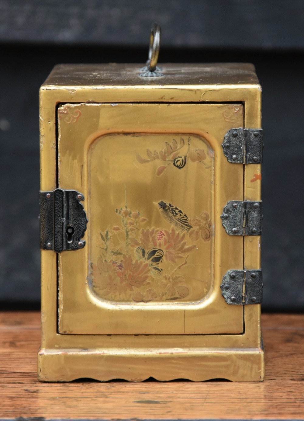 A nineteenth-century Japanese gilt lacquer kodansu cabinet displaying three internal drawers with gold botanical artwork and an open hinged door with flying crane details. View X