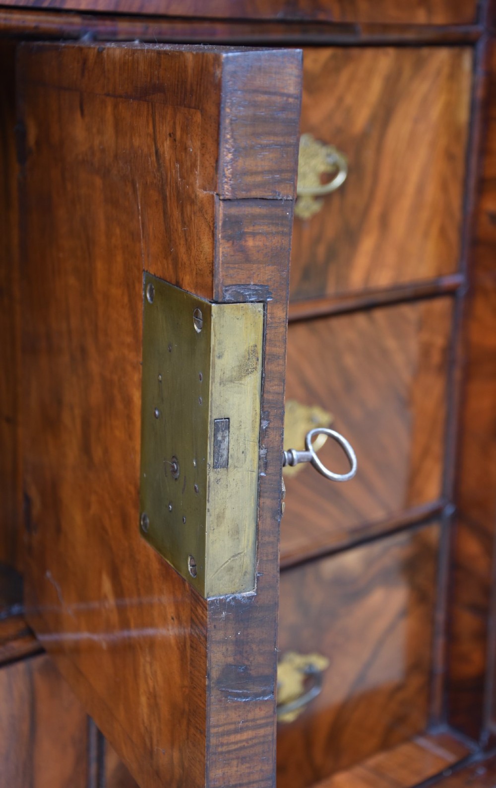 A late 17th-century William and Mary walnut cabinet on chest featuring double cupboard doors above drawers with brass mounts and bun feet. View X