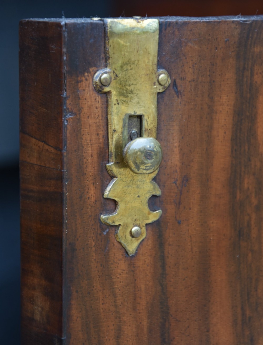 A late 17th-century William and Mary walnut cabinet on chest featuring double cupboard doors above drawers with brass mounts and bun feet. View XII