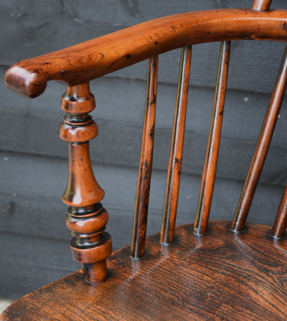 A matched pair of 18th-century Georgian Windsor armchairs crafted from warm brown yew and elm with hooped backs and turned legs. View VII