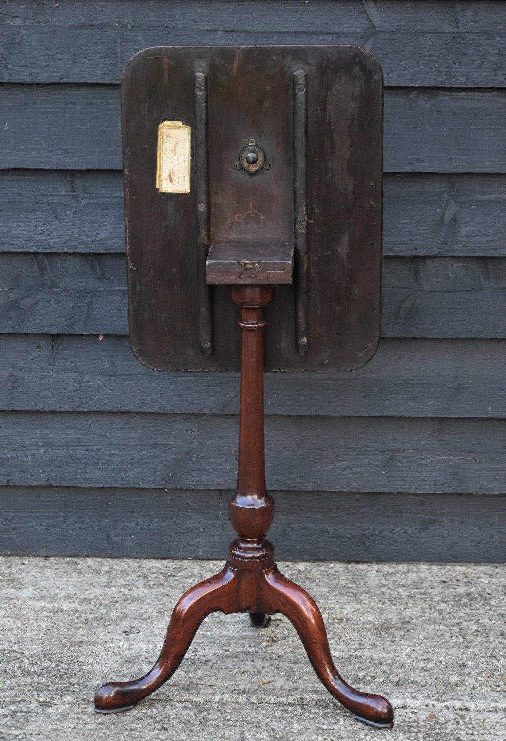 A 19th-century fruitwood tilt-top wine table featuring a rounded rectangular surface set upon a turned pedestal column with three cabriole legs. View VII