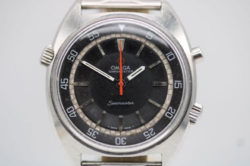 fig 1. A 1968 stainless steel Omega Seamaster Chronostop wristwatch with a black dial, inner rotating bezel, and central orange hand.