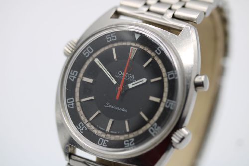 fig 2. A 1968 stainless steel Omega Seamaster Chronostop wristwatch with a black dial, inner rotating bezel, and central orange hand.