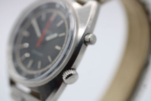 fig 4. A 1968 stainless steel Omega Seamaster Chronostop wristwatch with a black dial, inner rotating bezel, and central orange hand.