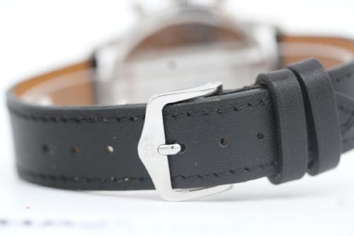 fig 2. A vintage 1969 Breitling Top Time wristwatch with a silver panda dial, two black sub-dials, a central red hand, and a black leather strap.