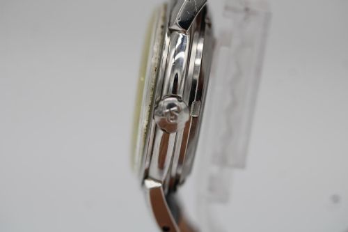 fig 2. A vintage 1952 Omega Seamaster Calendar wristwatch featuring a stainless steel case, textured gold-coloured dial with date display at six oclock, and a black leather strap.