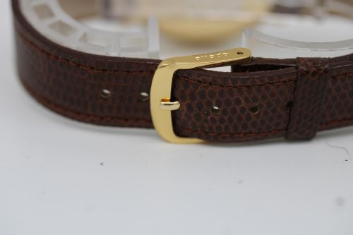 fig 3. A vintage circular 9ct gold wristwatch by Longines featuring a silver dial with gold baton hour markers and a brown leather strap.