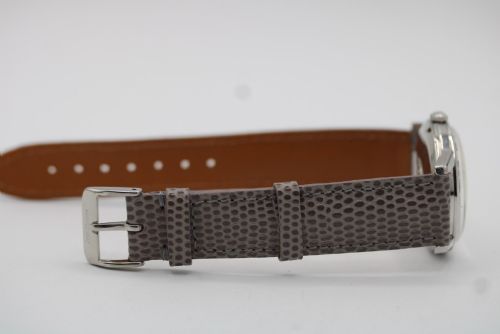fig 1. A vintage 1960 Omega Seamaster automatic wristwatch with a stainless steel case, silver cream dial, and grey textured leather strap.